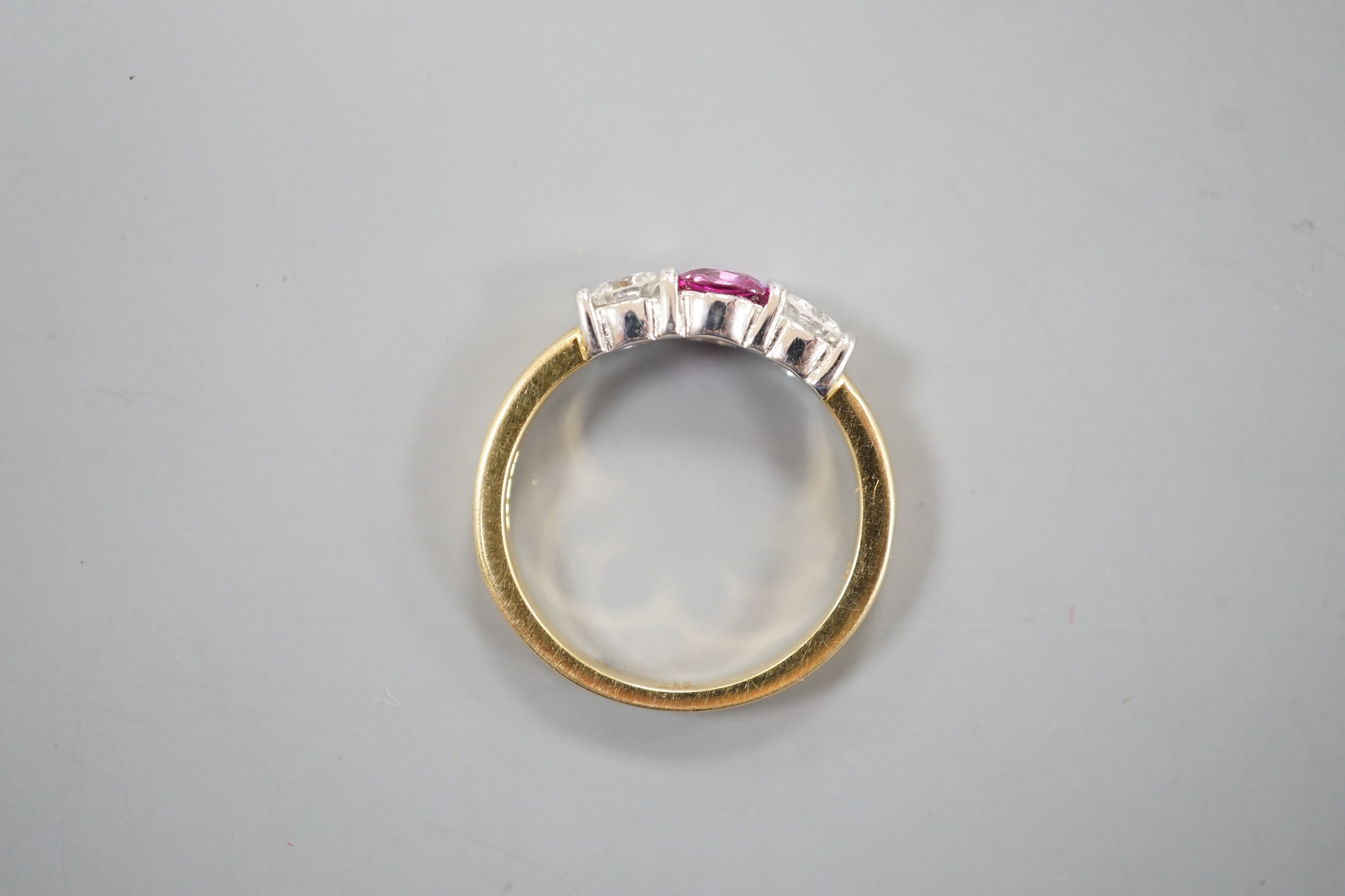 A modern 18ct white gold pink sapphire and diamond set three stone ring, size M, gross weight 4 grams